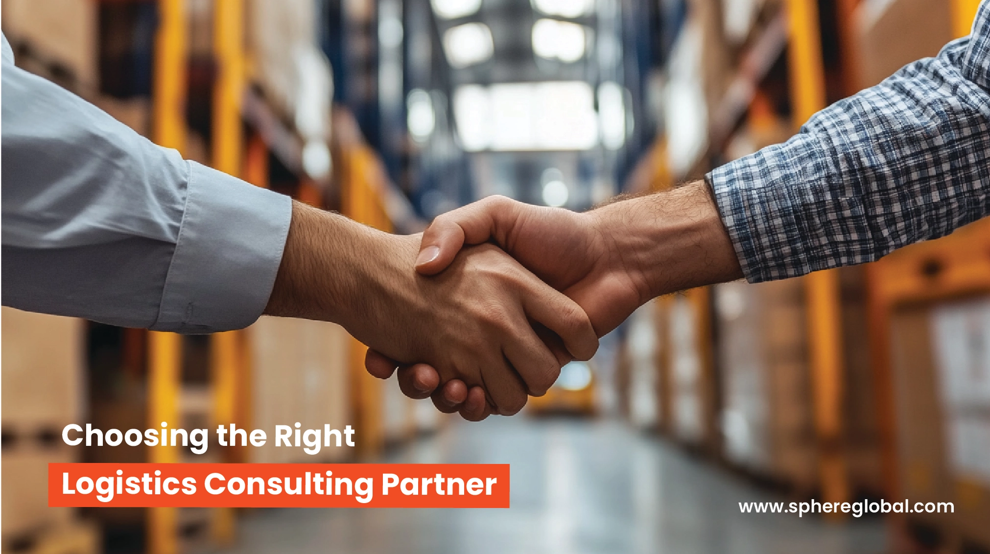 Logistics consulting partners shaking hands in a warehouse facility